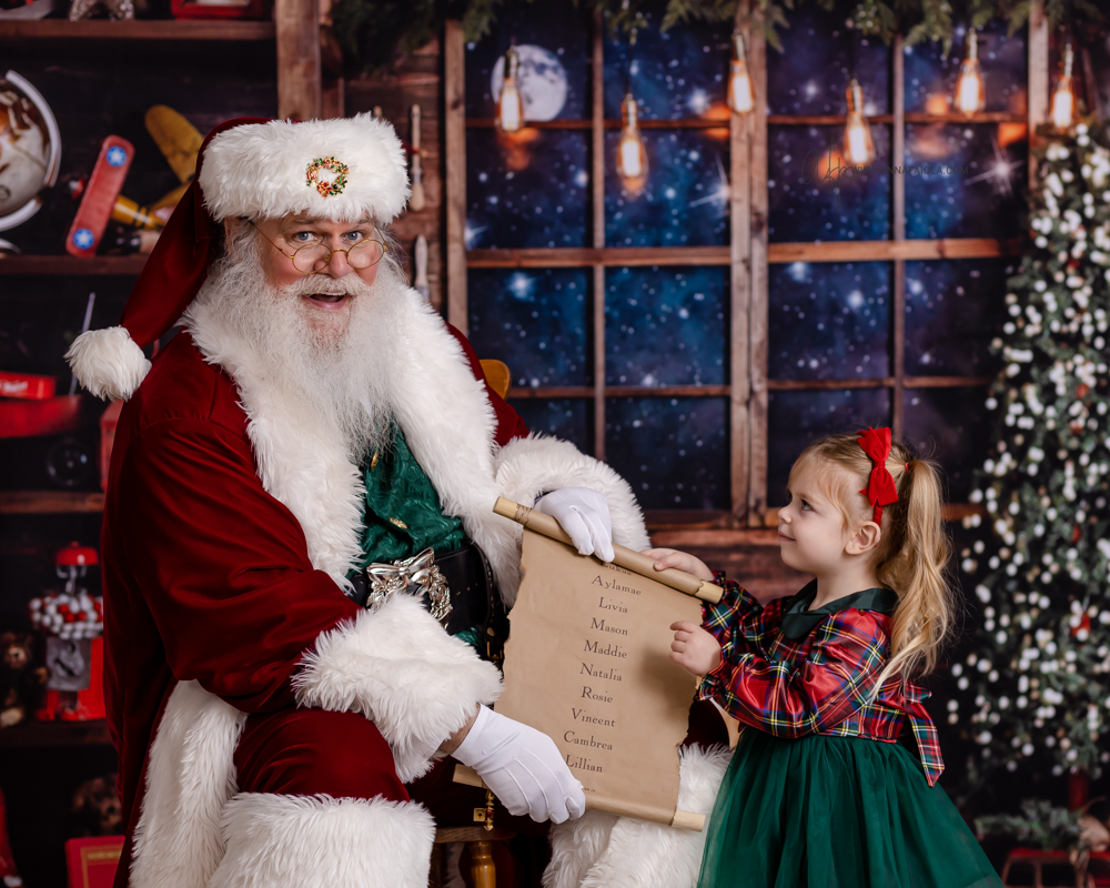 little girl pointing to Santa's Nice List