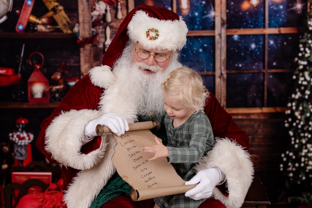 little girl with santa nice list photo session tampa