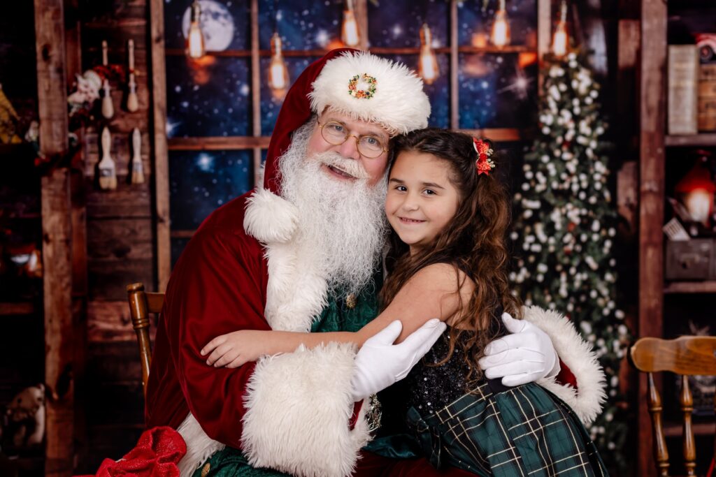 youg girl gives santa claus a big hug in tampa bay florida santa photos