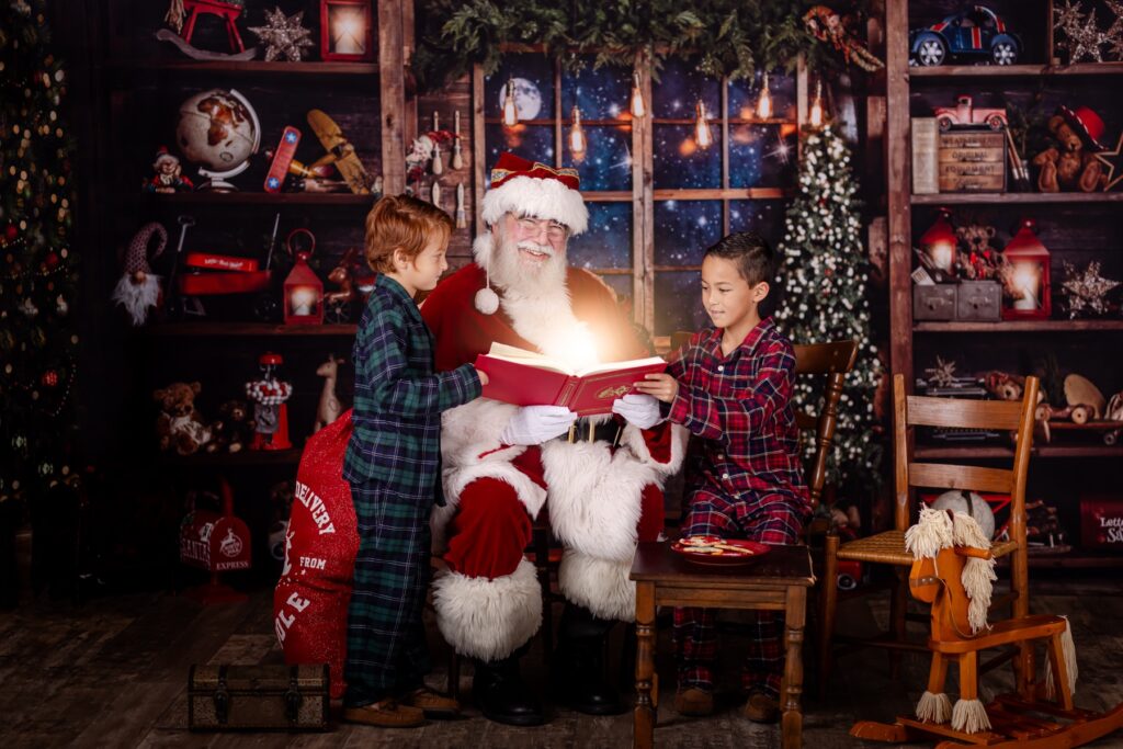 children reading a magical book with santa during a santa experience photo sesson