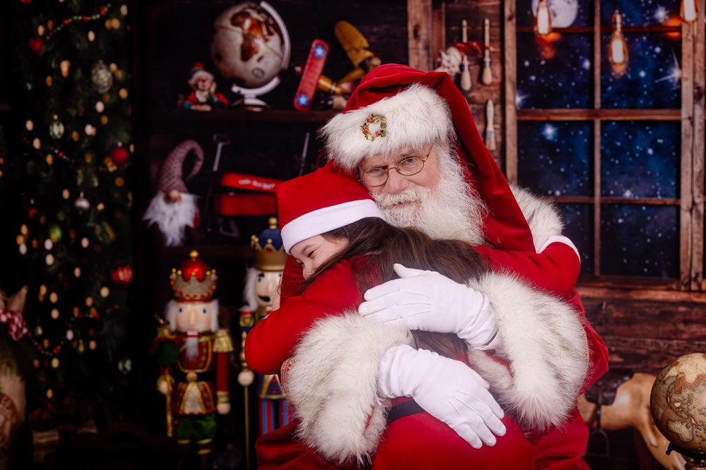 Child hugging Santa during photos in Palm Harbor