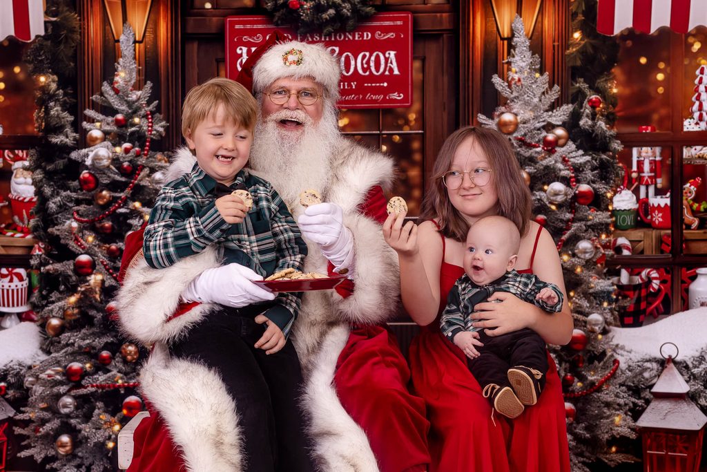 Children having cookies with Santa during a Santa photo experience in Palm Harbor Florida